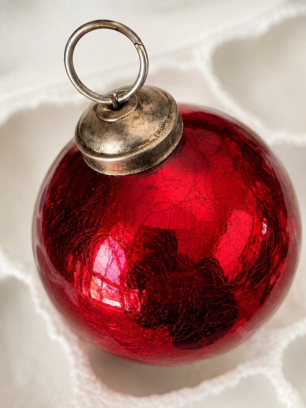 vintage-style red crackled glass ball ornament featuring aged silver metallic